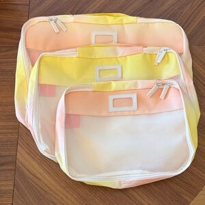 Calpak Gradient Ombré Yellow, Orange, and Pink Travel Organizer Set